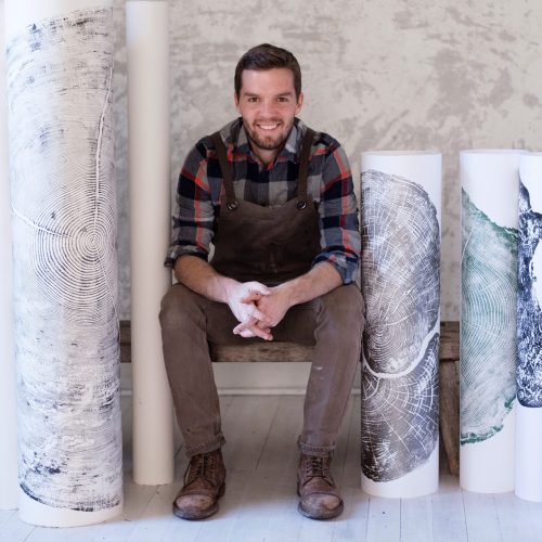 Erik Linton Surrounded by His Artworks